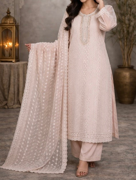 Elegant pastel pink suit crafted in dedicate embroidered fabric , featuring intricate threadwork on the neckline and panels , paired with a sheer floral dupatta for a graceful and timeless look