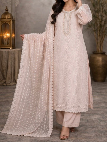 Elegant pastel pink suit crafted in dedicate embroidered fabric , featuring intricate threadwork on the neckline and panels , paired with a sheer floral dupatta for a graceful and timeless look