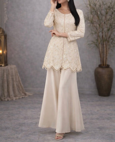 Ivory suit set crafted with dedicate hand embroidery, featuring a scalloped hem kurta paired with flowy palazzo pants