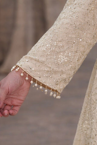 Ivory suit set crafted with dedicate hand embroidery, featuring a scalloped hem kurta paired with flowy palazzo pants