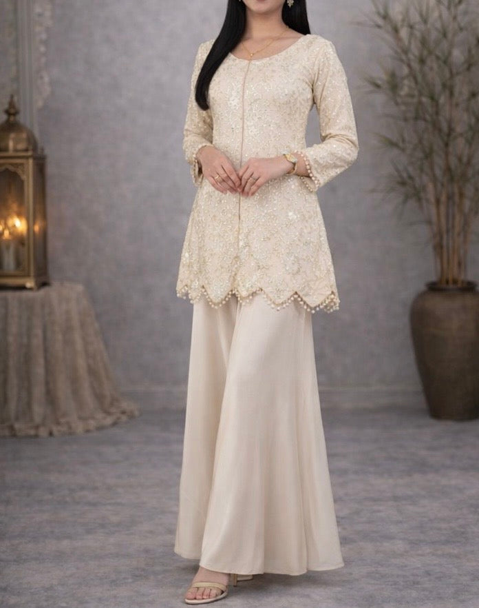 Ivory suit set crafted with dedicate hand embroidery, featuring a scalloped hem kurta paired with flowy palazzo pants