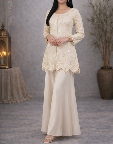 Ivory suit set crafted with dedicate hand embroidery, featuring a scalloped hem kurta paired with flowy palazzo pants